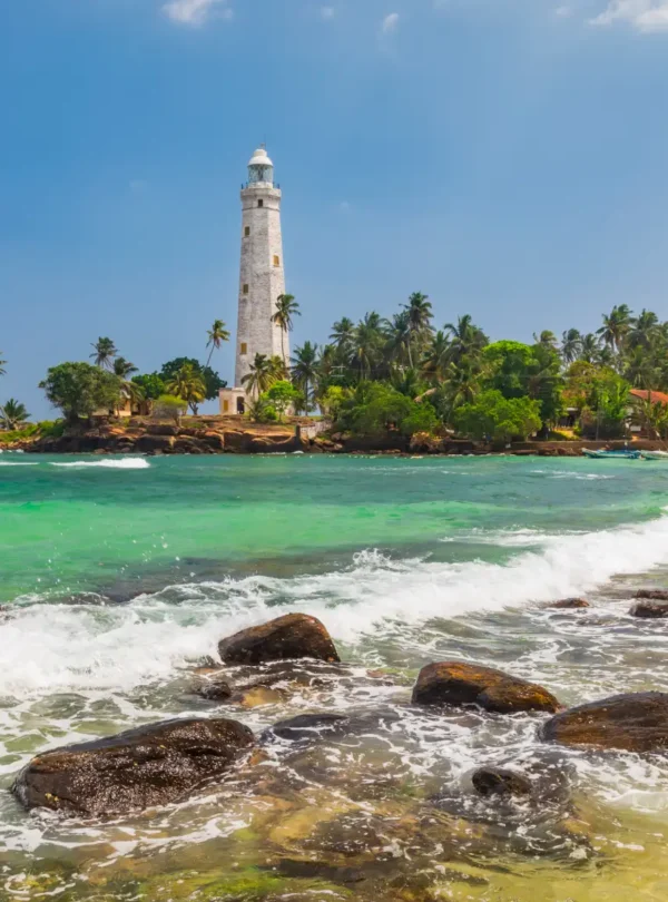 Dondra Head lighthouse and palm trees near Galle, Sri Lanka